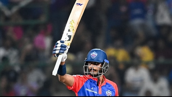 Axar Patel raises his bat after scoring a half-century against Mumbai Indians at IPL 2023(AFP)