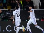 Karim Benzema, right, celebrates after scoring his side's 3rd goal with Real Madrid's Vinicius Junior 