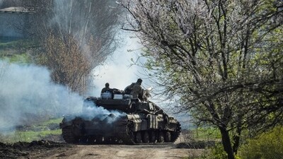 Ukrainian service members ride a tank, as Russia's attack on Ukraine continues, near the front line city of Bakhmut, Ukraine. (REUTERS)