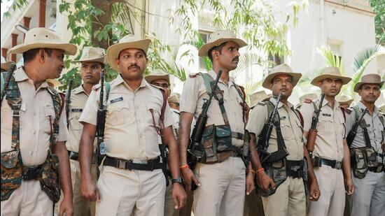 Railway Protection Special Force, Karnataka Special Reserve Police and local police personnel conduct a route march ahead of the Karnataka assembly elections in Bengaluru. (PTI)