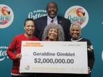 Geraldine Gimblet holding a giant lottery cheque at the Florida headquarters. 