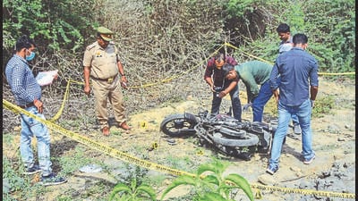 Police personnel inspect a two-wheeler at the site of the encounter in which jailed mafia Atiq Ahmad's son Asad was killed by the UP STF, in Jhansi, on Thursday. (PTI) Police personnel inspect a two-wheeler at the site of the encounter in which jailed mafia Atiq Ahmad's son Asad was killed by the UP STF, in Jhansi, on Thursday. (PTI)