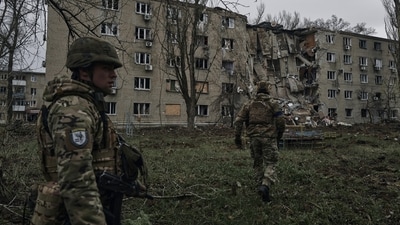 Ukrainian soldiers pass by an apartment building damaged by the recent Russian shelling in war-hit Avdiivka, Donetsk region, Ukraine, Wednesday, April 12, 2023. (AP)