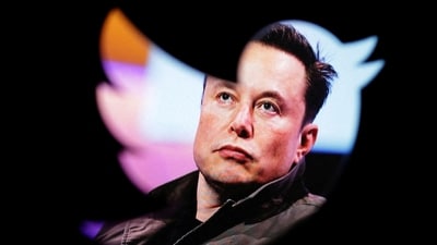 Elon Musk's photo is seen through a Twitter logo in this illustration. (REUTERS)