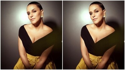Neha looked gorgeous in a black off shoulder bodycon gown with a dramatic yellow throw tied to the waist adding to the train. (Instagram/@nehadhupia) Neha looked gorgeous in a black off shoulder bodycon gown with a dramatic yellow throw tied to the waist adding to the train. (Instagram/@nehadhupia)