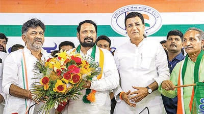 Karnataka Congress chief DK Shivakumar and state incharge Randeep Singh Surjewala felicitates ex-Karnataka deputy CM Laxman Savadi in Bengaluru on Friday. (PTI) Karnataka Congress chief DK Shivakumar and state incharge Randeep Singh Surjewala felicitates ex-Karnataka deputy CM Laxman Savadi in Bengaluru on Friday. (PTI)