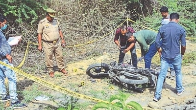 Police personnel inspect a two-wheeler at the site of the encounter in which jailed mafia Atiq Ahmad's son Asad was killed by the UP STF, in Jhansi, on Thursday. (PTI) Police personnel inspect a two-wheeler at the site of the encounter in which jailed mafia Atiq Ahmad's son Asad was killed by the UP STF, in Jhansi, on Thursday. (PTI)