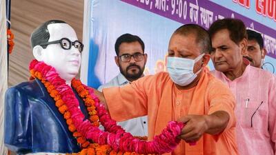 Uttar Pradesh chief minister Yogi Adityanath offering floral tribute to a statue of Babasaheb Dr BR Ambedkar in Lucknow on Friday. (ANI PHOTO)