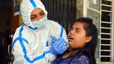 A health worker collects a swab sample for the Covid-19 test, at Daryaganj Dispensary amid a surge in cases, in New Delhi on Thursday. (ANI) A health worker collects a swab sample for the Covid-19 test, at Daryaganj Dispensary amid a surge in cases, in New Delhi on Thursday. (ANI)