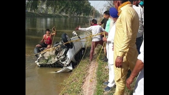 The car being fished out of Sirhind feeder canal in Faridkot on Friday. (HT photo)