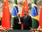 Brazilian President Luiz Inacio Lula da Silva, left, shakes hands with Chinese President Xi Jinping after a signing ceremony in Beijing.