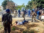 Police personnel wield batons against Bharatiya Janata Party (BJP) supporters to disperse them during BJP's protest against the state government, near the secretariat in Ranchi, Tuesday, April 11, 2023. (PTI)
