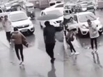 The image, taken from viral video, shows a man offering his umbrella to a mother and a child on a rainy day. The image, taken from viral video, shows a man offering his umbrella to a mother and a child on a rainy day.