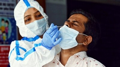 A health worker collects a swab sample for the Covid-19 test, at Daryaganj Dispensary amid a surge in cases, in New Delhi on Thursday. (ANI)