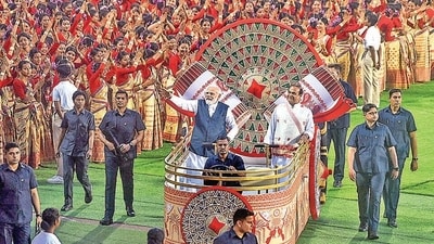Prime Minister Narendra Modi wave towards the waiting Assamese dancers and musicians ahead of their performance (PTI) Prime Minister Narendra Modi wave towards the waiting Assamese dancers and musicians ahead of their performance (PTI)