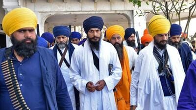 Radical Sikh leader Amritpal Singh (centre) has been declared a fugitive after he escaped the Punjab Police crackdown at a busy market in Mehatpur town in Jalandhar district by switching vehicles and changing his appearance on March 18. (HT file photo) Radical Sikh leader Amritpal Singh (centre) has been declared a fugitive after he escaped the Punjab Police crackdown at a busy market in Mehatpur town in Jalandhar district by switching vehicles and changing his appearance on March 18. (HT file photo)