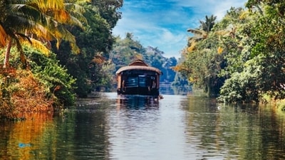 The Backwaters of Kumarakom: The stunning backwaters of Kumarakom are a magnificent network of lagoons, canals, and lakes. You can rent a houseboat and sail through these waterways, surrounded by coconut trees and greenery. The calmness and tranquility of this place are perfect for a relaxing getaway. (Unsplash) The Backwaters of Kumarakom: The stunning backwaters of Kumarakom are a magnificent network of lagoons, canals, and lakes. You can rent a houseboat and sail through these waterways, surrounded by coconut trees and greenery. The calmness and tranquility of this place are perfect for a relaxing getaway. (Unsplash)