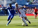 Getafe's Djene in action with FC Barcelona's Ronald Araujo