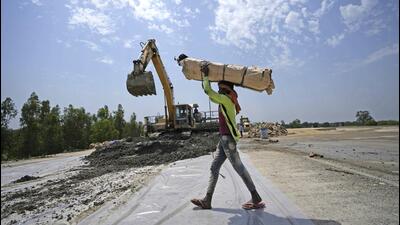 A labourer works in the construction of a highway on the outskirts of Jammu on Saturday. (AP) A labourer works in the construction of a highway on the outskirts of Jammu on Saturday. (AP)