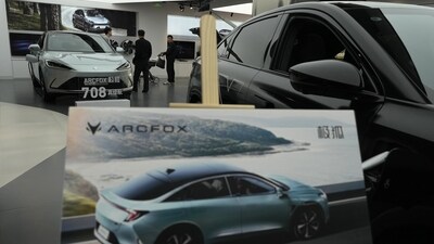Visitors look at the Arcfox a-S, an all electric car from Chinese automaker BAIC which claims to have a 708km range on a single charge at a show room in Beijing. (AP) Visitors look at the Arcfox a-S, an all electric car from Chinese automaker BAIC which claims to have a 708km range on a single charge at a show room in Beijing. (AP)