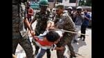 Police detain a student during a protest march in Ranchi on Monday. (ANI)