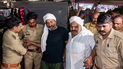 Gangster-politician Atiq Ahmed and his brother Ashraf Ahmed being escorted to a hospital by police for a medical check-up, in Prayagraj, Saturday, April 15, 2023. (PTI Photo) Gangster-politician Atiq Ahmed and his brother Ashraf Ahmed being escorted to a hospital by police for a medical check-up, in Prayagraj, Saturday, April 15, 2023. (PTI Photo)