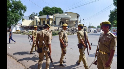 Police personnel deployed outside the Kasari Masari office of gangster-turned-politician Atiq Ahmad. (PTI) Police personnel deployed outside the Kasari Masari office of gangster-turned-politician Atiq Ahmad. (PTI)