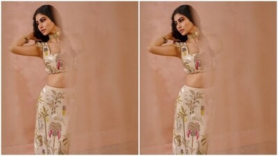 In an ivory white sleeveless cropped top and a matching long skirt featuring embroidery work in multicoloured resham threads, Mouni looked gorgeous as ever. (Instagram/@payalsinghal) In an ivory white sleeveless cropped top and a matching long skirt featuring embroidery work in multicoloured resham threads, Mouni looked gorgeous as ever. (Instagram/@payalsinghal)