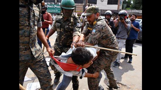 Police detain a student during a protest march in Ranchi on Monday. (ANI)