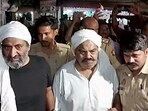 Police personnel escort gangster-politician Atiq Ahmed to a 'routine' medical check-up in Prayagraj in Uttar Pradesh on Thursday. (File photo) Police personnel escort gangster-politician Atiq Ahmed to a 'routine' medical check-up in Prayagraj in Uttar Pradesh on Thursday. (File photo)
