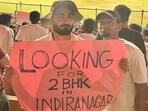 The image shows fans holding up a placard at RCB vs DC IPL match. The image shows fans holding up a placard at RCB vs DC IPL match.