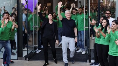 Apple CEO Tim Cook and Deirdre O'Brien, Apple's senior vice president of Retail and People greet people at the inauguration of India's first Apple retail store in Mumbai, India. (REUTERS)