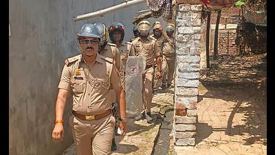 Police personnel during a search for Shaista Parveen, wife of slain gangster-turned-politician Atiq Ahmad, near Prayagraj, Tuesday. (PTI)