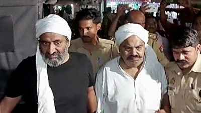 Police personnel escort gangster-politician Atiq Ahmed to a 'routine' medical check-up in Prayagraj in Uttar Pradesh on Thursday. (File photo)