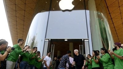 Apple CEO Tim Cook shakes hands with a customer during the opening of the new Apple BKC store in Mumbai. (Bloomberg) Apple CEO Tim Cook shakes hands with a customer during the opening of the new Apple BKC store in Mumbai. (Bloomberg)