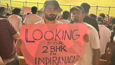 The image shows fans holding up a placard at RCB vs DC IPL match. (Twitter/@BoseAtin) The image shows fans holding up a placard at RCB vs DC IPL match. (Twitter/@BoseAtin)