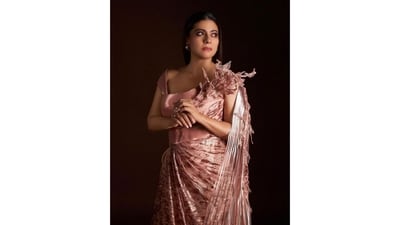 Kajol wore a custom-made rose gold sequinned saree-gown with hand-embroidered leaves and a metallic, polymer-winged drape. The structured bustier sculpted her body and added glamour to the outfit. (Instagram/@kajol) Kajol wore a custom-made rose gold sequinned saree-gown with hand-embroidered leaves and a metallic, polymer-winged drape. The structured bustier sculpted her body and added glamour to the outfit. (Instagram/@kajol)
