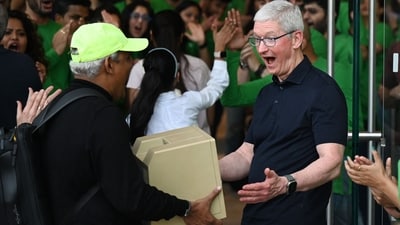 Man brings a Macintosh SE computer during the launch of Apple's first-ever retail store in India, Cook looks surprised. (AFP) Man brings a Macintosh SE computer during the launch of Apple's first-ever retail store in India, Cook looks surprised. (AFP)