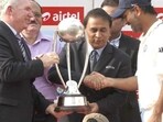 Former Australian and Indian cricket captains Allan Border and Sunil Gavaskar present the trophy to MS Dhoni Former Australian and Indian cricket captains Allan Border and Sunil Gavaskar present the trophy to MS Dhoni