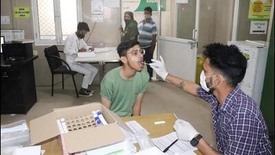 A health worker collects a swab sample for Covid testing at a hospital in Ghaziabad on Wednesday. (Sakib Ali/HT Photo) A health worker collects a swab sample for Covid testing at a hospital in Ghaziabad on Wednesday. (Sakib Ali/HT Photo)