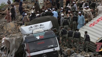 Pakistan Landslide: Paramilitary soldiers, rescue workers and volunteers search for survivors through the rubble at the site of landslide near the Torkham border town. (AP) Pakistan Landslide: Paramilitary soldiers, rescue workers and volunteers search for survivors through the rubble at the site of landslide near the Torkham border town. (AP)
