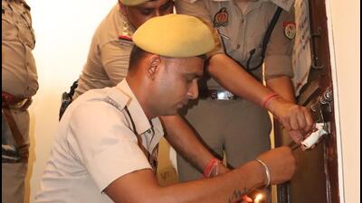 Ghaziabad police attach a property of Lakshya Tanwar on Wednesday. (Sakib Ali/HT Photo) Ghaziabad police attach a property of Lakshya Tanwar on Wednesday. (Sakib Ali/HT Photo)