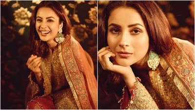 Shehnaaz Gill's salwar suit has a kurta featuring full-length sleeves, a round neckline, heavy gold embroidery, and embellished patti borders. She paired it with multi-coloured pants decorated with intricate gold floral work. (Instagram) Shehnaaz Gill's salwar suit has a kurta featuring full-length sleeves, a round neckline, heavy gold embroidery, and embellished patti borders. She paired it with multi-coloured pants decorated with intricate gold floral work. (Instagram)
