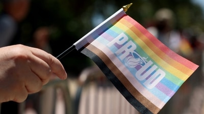 A parade-goer holds a flag as she watches as the 15th annual Miami Beach Pride Celebration parade passes by on April 16, 2023 in Miami Beach, Florida. (Photo by JOE RAEDLE / GETTY IMAGES NORTH AMERICA / Getty Images via AFP) A parade-goer holds a flag as she watches as the 15th annual Miami Beach Pride Celebration parade passes by on April 16, 2023 in Miami Beach, Florida. (Photo by JOE RAEDLE / GETTY IMAGES NORTH AMERICA / Getty Images via AFP)