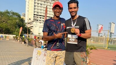 Angad Bedi poses with his coach Brinston Miranada after winning his first silver medal in a 400m race.