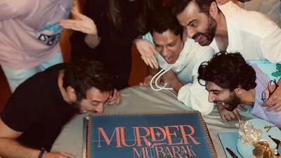 The team of Murder Mubarak celebrated the Delhi schedule wrap with a huge cake with the name of the film written on it. The candid picture shows the star cast eager to eat the cake. The team of Murder Mubarak celebrated the Delhi schedule wrap with a huge cake with the name of the film written on it. The candid picture shows the star cast eager to eat the cake. 