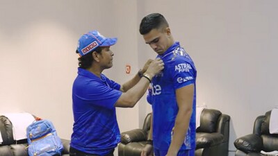 Sachin Tendulkar awards a badge to son Arjun Sachin Tendulkar awards a badge to son Arjun