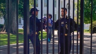 A toddler, who briefly entered the White House, being escorted by Secret Service officers. (AP) A toddler, who briefly entered the White House, being escorted by Secret Service officers. (AP)