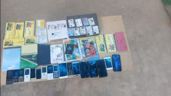 Thte police recovered 67 mobile phones, two tablets, 13 SIM cards, four dongles, seven registry certificates, deeds, 17 debit cards, bank statements, seven vehicles including a Scorpio and a Fortuner, 10 signed blank cheques, 18 cheque books, 28 passbooks, two currency counting machines, and 275 pages related to various transactions from the suspects. (HT Photo)