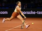 Belarus' Aryna Sabalenka returns the ball to Czech Republic's Barbora Krejcikova during the 2nd round of the WTA Stuttgart tennis match at the Porsche Arena in Stuttgart, Germany, Wednesday, April 19, 2023. (Marijan Murat/dpa via AP)